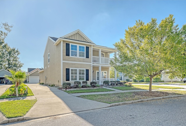 view of front of property featuring a balcony, a garage, covered porch, and a front yard