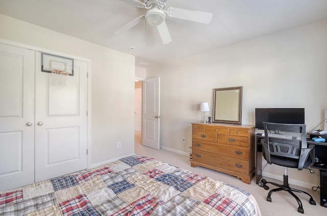 carpeted bedroom featuring a closet and ceiling fan