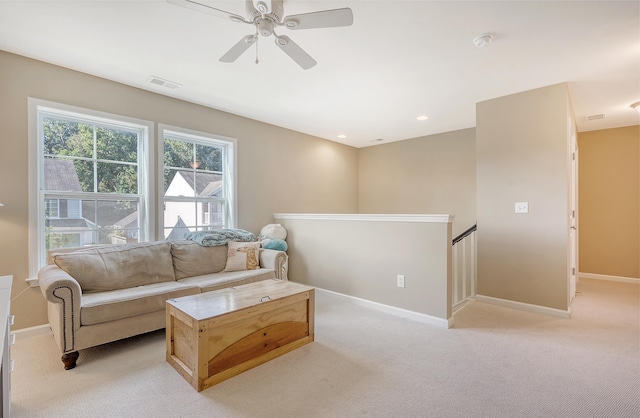 carpeted living room featuring ceiling fan