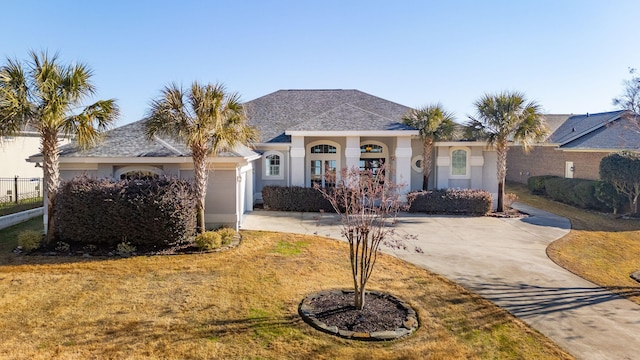 ranch-style house with a garage and a front yard