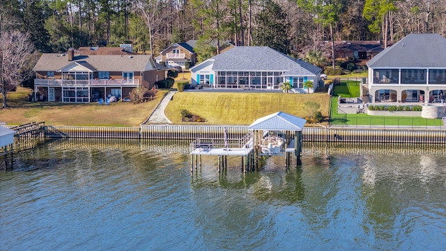 view of dock with a water view and a lawn