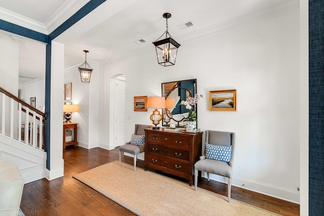 1527 Wando View St, Charleston, SC 29492 - living area featuring wood finished floors, arched walkways, crown molding, stairs, and baseboards