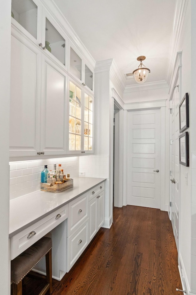 1527 Wando View St, Charleston, SC 29492 - bar featuring decorative backsplash, dark wood-style flooring, ornamental molding, and a chandelier
