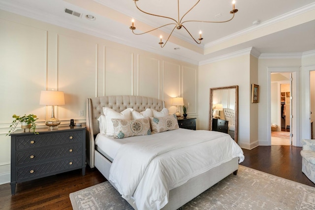 1527 Wando View St, Charleston, SC 29492 - bedroom with dark wood-style flooring, a chandelier, ornamental molding, a decorative wall, and a tray ceiling