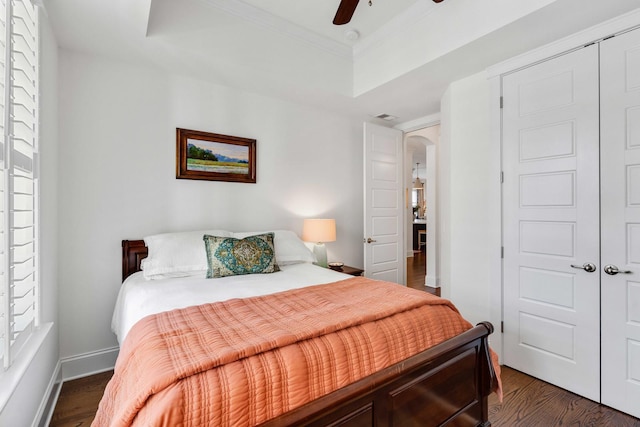 1527 Wando View St, Charleston, SC 29492 - bedroom featuring a tray ceiling, arched walkways, dark wood-type flooring, ornamental molding, and baseboards