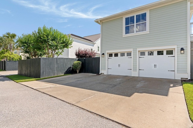 1527 Wando View St, Charleston, SC 29492 - view of home's exterior featuring an attached garage, concrete driveway, and fence