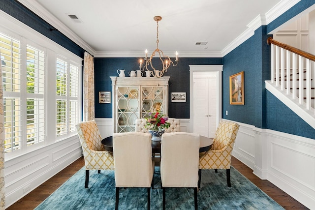 1527 Wando View St, Charleston, SC 29492 - dining area with a chandelier, ornamental molding, dark wood-style flooring, wainscoting, and a decorative wall