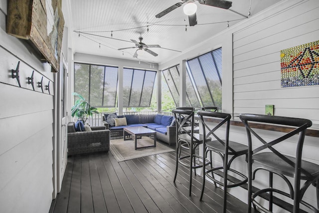 sunroom with an outdoor living space and a ceiling fan