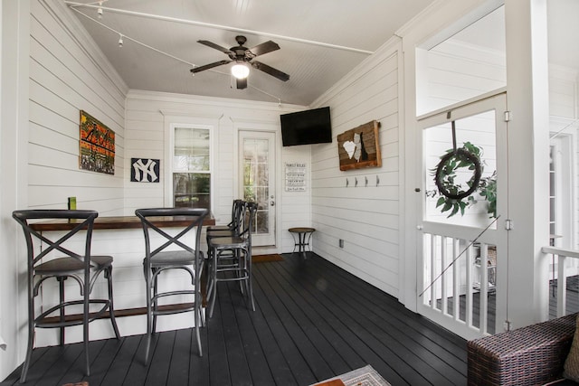 wooden terrace with a ceiling fan and outdoor dry bar