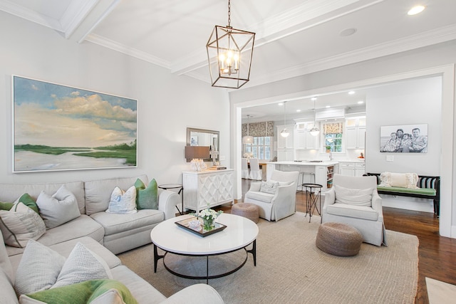 living area featuring an inviting chandelier, beam ceiling, recessed lighting, wood finished floors, and ornamental molding