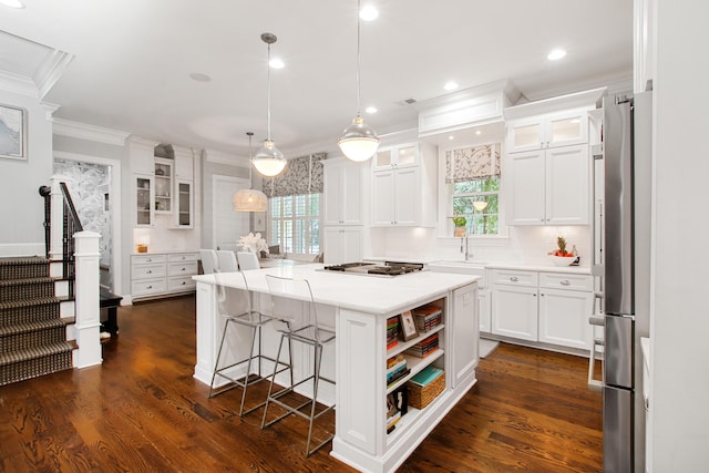 kitchen with crown molding, light countertops, white cabinets, and stainless steel appliances