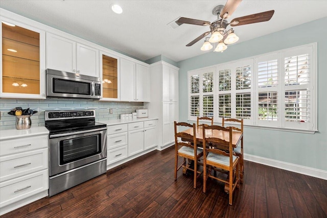 kitchen featuring tasteful backsplash, dark wood-type flooring, white cabinets, and stainless steel appliances