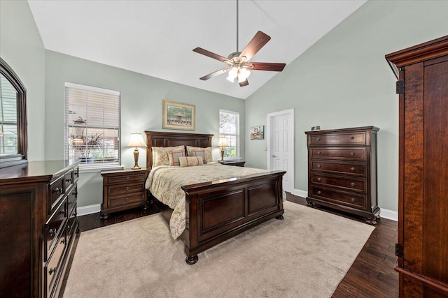 bedroom with ceiling fan, dark wood-type flooring, and vaulted ceiling