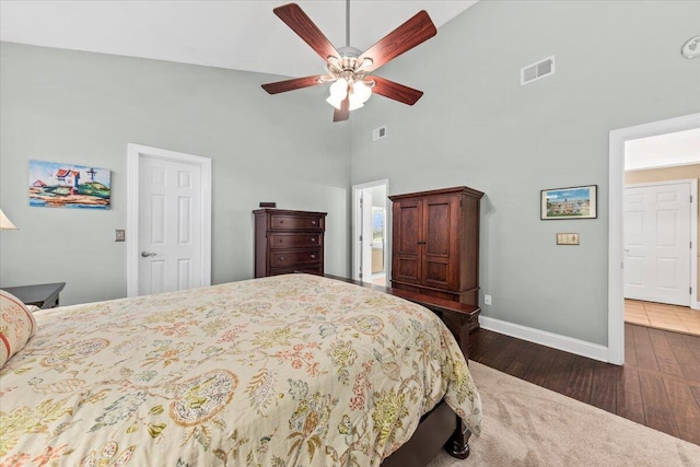 bedroom featuring dark hardwood / wood-style flooring, high vaulted ceiling, and ceiling fan