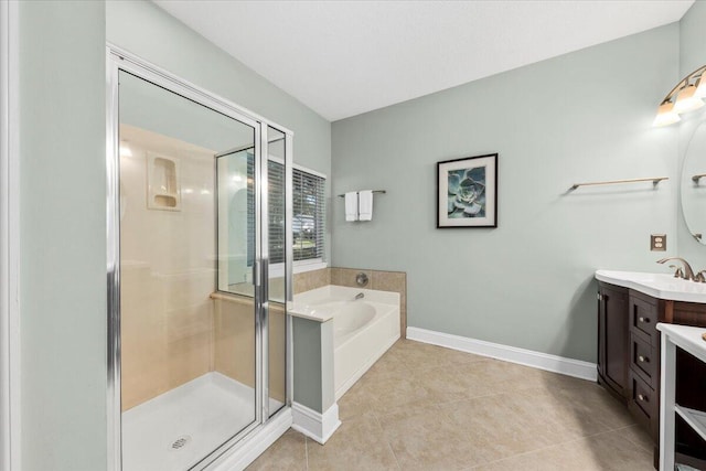 bathroom featuring tile patterned flooring, vanity, and separate shower and tub