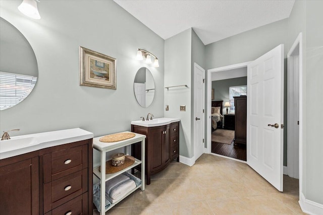 bathroom featuring tile patterned flooring and vanity