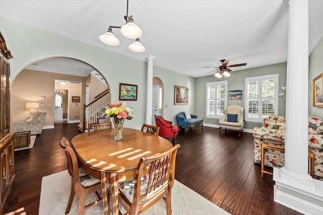 dining space with a textured ceiling, dark hardwood / wood-style floors, ceiling fan, and decorative columns