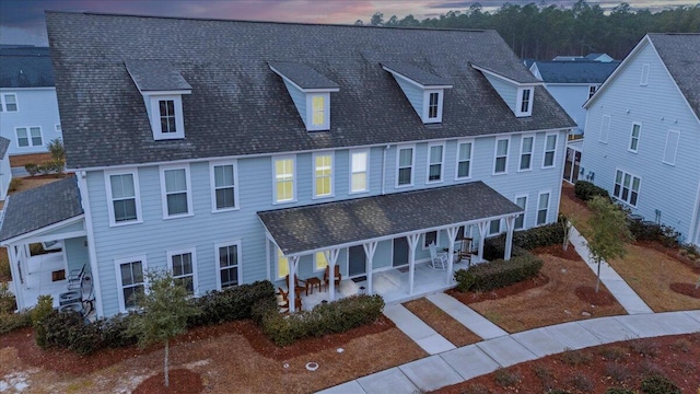 view of front of house with a porch and a patio area