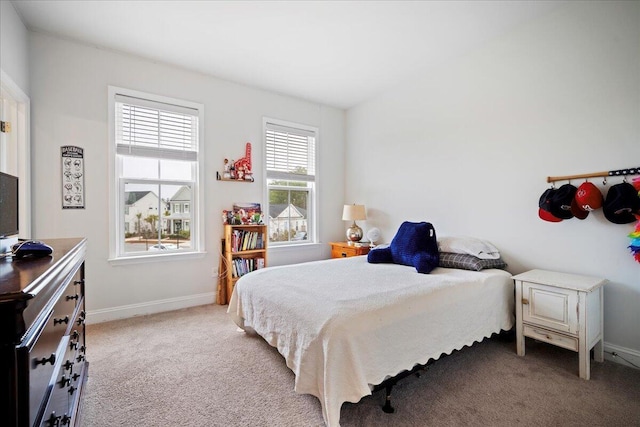 bedroom featuring light colored carpet