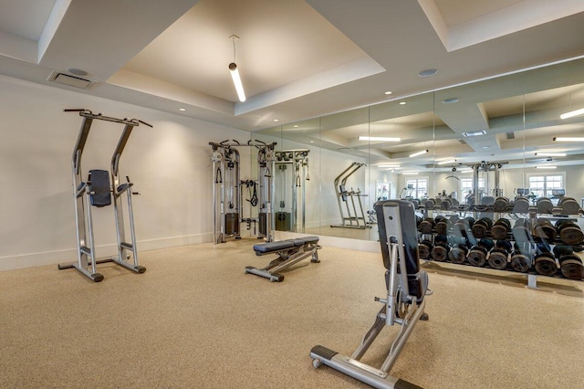 exercise room with a tray ceiling