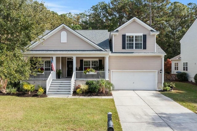 view of front of property featuring a porch, a garage, and a front yard