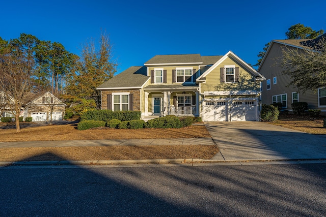 view of front of house featuring covered porch and a garage