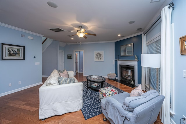 living room featuring dark hardwood / wood-style flooring, ceiling fan, and ornamental molding