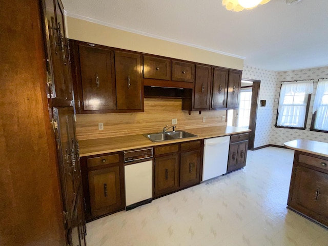 kitchen with wallpapered walls, white dishwasher, dark brown cabinets, light floors, and a sink