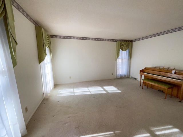 unfurnished room featuring carpet flooring and visible vents