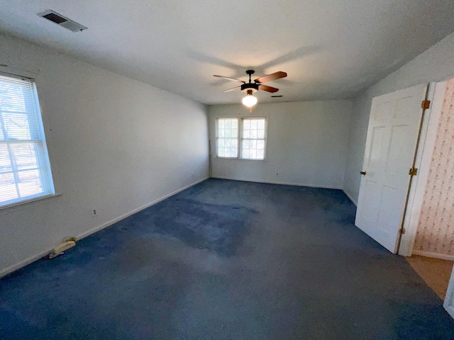 empty room featuring baseboards, carpet, visible vents, and a ceiling fan