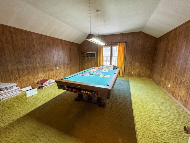 recreation room featuring lofted ceiling, carpet floors, a textured ceiling, and wooden walls