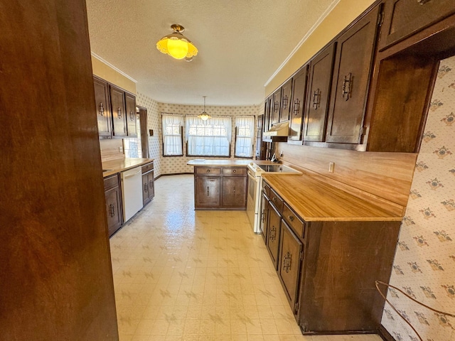 kitchen featuring light floors, dark brown cabinetry, white appliances, a peninsula, and wallpapered walls