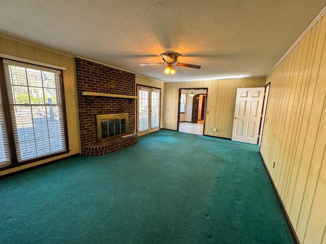 unfurnished living room featuring carpet floors, crown molding, and plenty of natural light