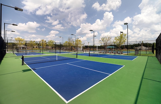 view of tennis court with fence and community basketball court