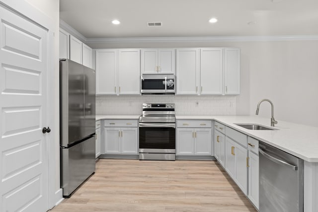 5133 Park Creek Ave, North Charleston, SC 29418 - kitchen with stainless steel appliances, a sink, crown molding, a peninsula, and light countertops