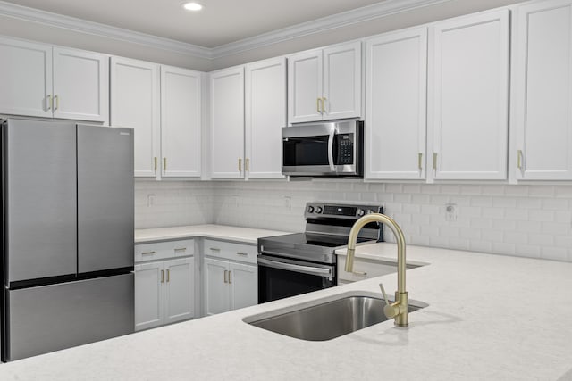 5133 Park Creek Ave, North Charleston, SC 29418 - kitchen with stainless steel appliances, white cabinets, a sink, crown molding, and decorative backsplash