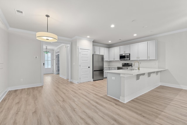 5133 Park Creek Ave, North Charleston, SC 29418 - kitchen featuring stainless steel appliances, crown molding, a peninsula, light countertops, and decorative backsplash