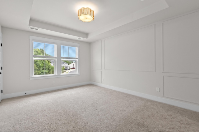 5133 Park Creek Ave, North Charleston, SC 29418 - spare room featuring a tray ceiling, light carpet, and baseboards
