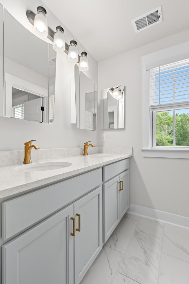 5133 Park Creek Ave, North Charleston, SC 29418 - full bathroom featuring double vanity, marble look tile flooring, and baseboards