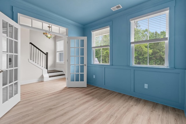 5133 Park Creek Ave, North Charleston, SC 29418 - empty room with french doors, wood finished floors, crown molding, stairway, and healthy amount of natural light