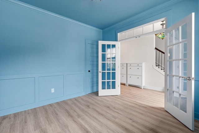 5133 Park Creek Ave, North Charleston, SC 29418 - empty room featuring french doors, crown molding, wood finished floors, stairway, and a decorative wall
