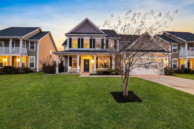 view of front facade with board and batten siding, a garage, driveway, and a front lawn