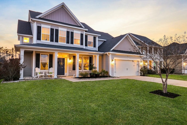 view of front of property with covered porch, concrete driveway, a front lawn, and board and batten siding