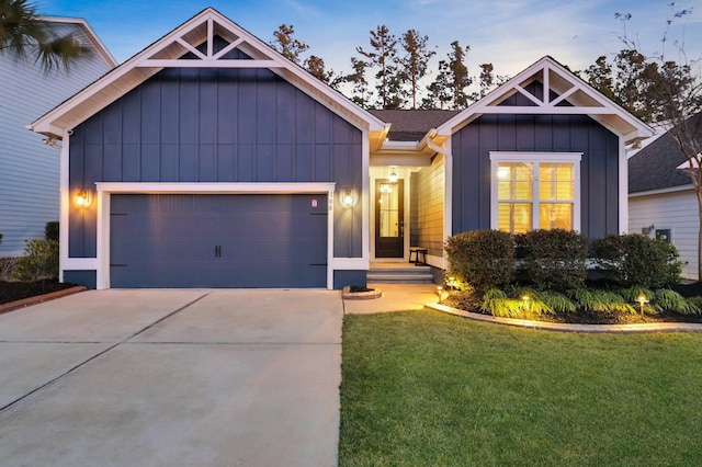 view of front of house with concrete driveway, a front lawn, board and batten siding, and an attached garage