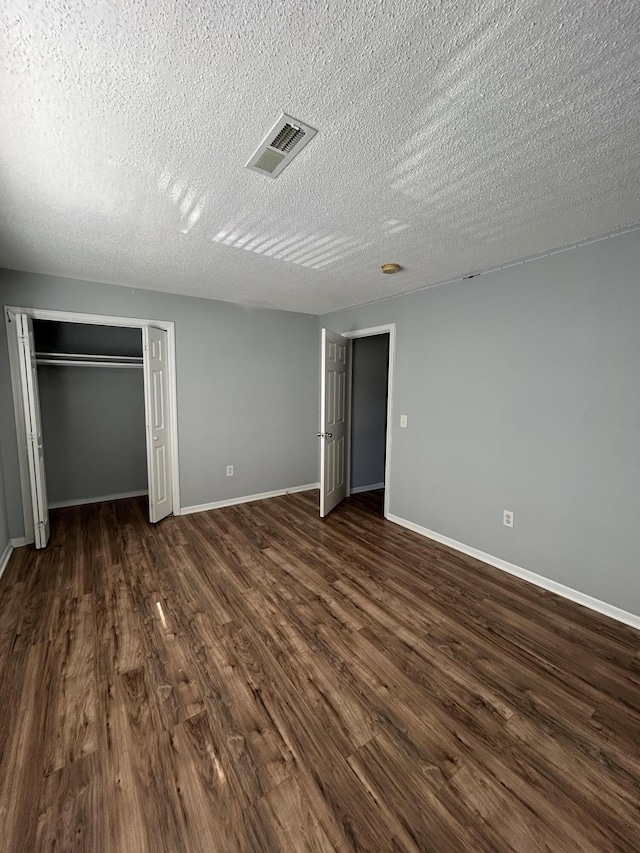 415 Parkdale Dr Unit 6D, Charleston, SC 29414 - unfurnished bedroom with a textured ceiling and dark wood finished floors