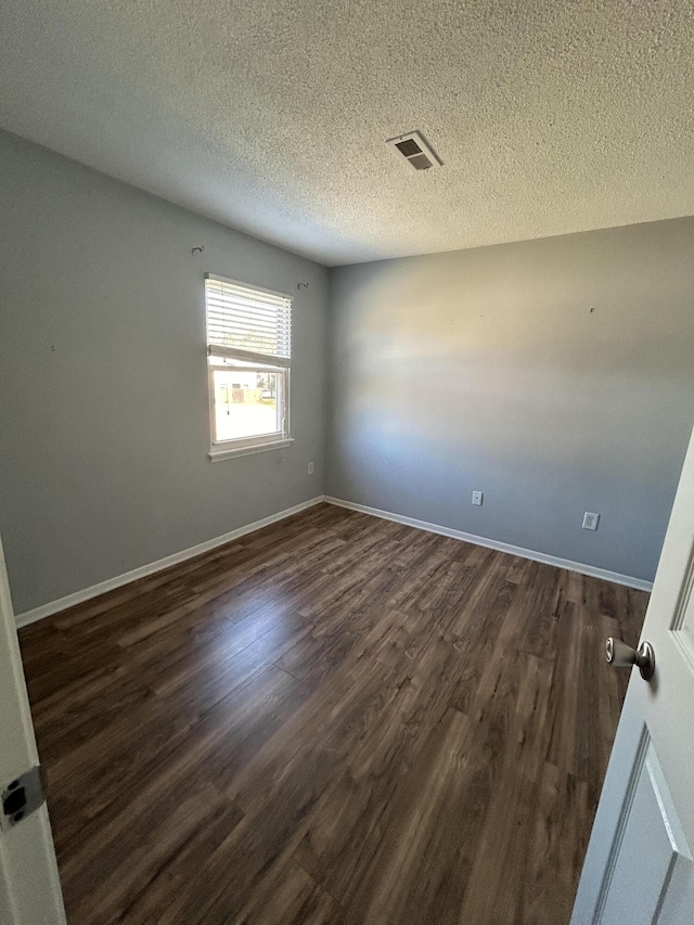 415 Parkdale Dr Unit 6D, Charleston, SC 29414 - spare room featuring dark wood-style flooring and a textured ceiling