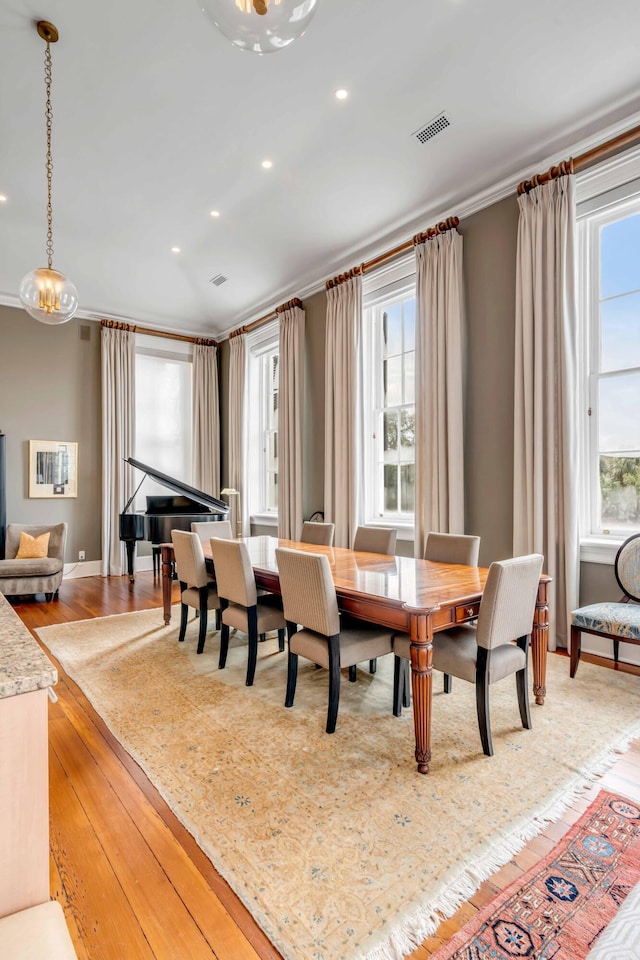 dining area featuring light wood-style flooring, visible vents, a wealth of natural light, and recessed lighting