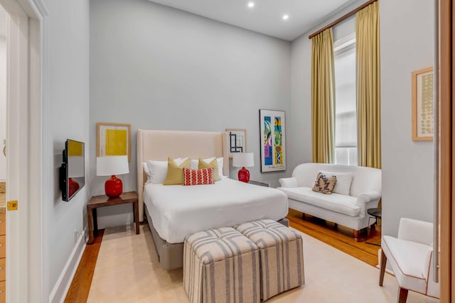 bedroom with light wood-type flooring, baseboards, and recessed lighting