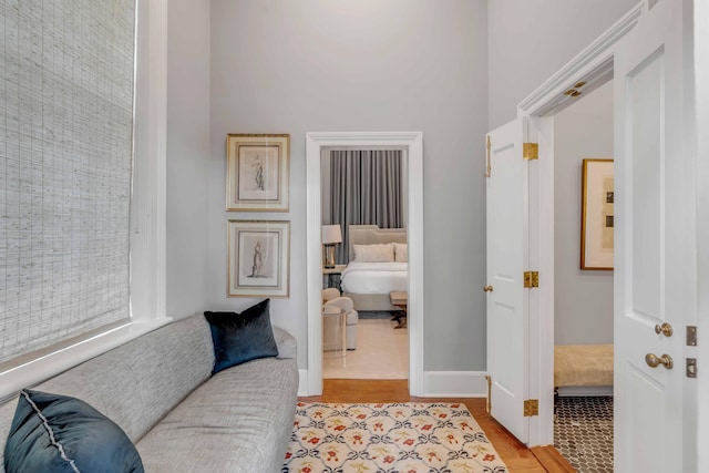 living area featuring light wood-style flooring and baseboards