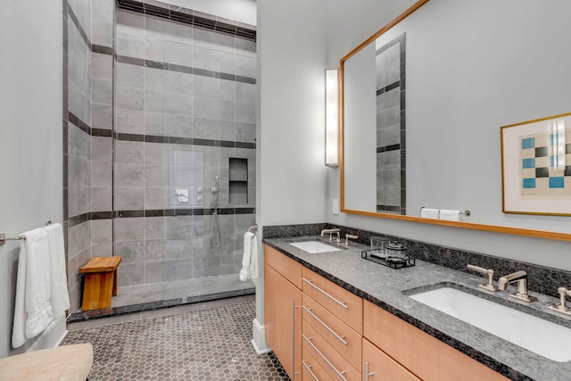 bathroom featuring a sink, a shower stall, and double vanity